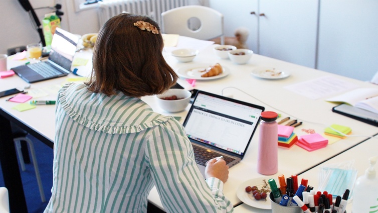 A female designer sitting in front of a laptop